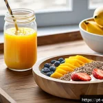 Home 18 우울증 환자를 위한 빠른 조리법 - A vibrant breakfast scene featuring a colorful smoothie bowl on a rustic wooden table, filled with b...